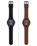 Two men's analog watches shown side by side on a white background. The watch on the left has a black silicone strap and a dark blue-purple dial.